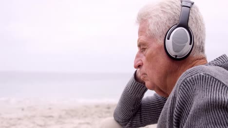 thoughtful retired man listening to music