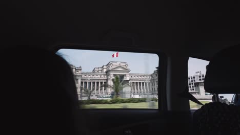 view of the palace of justice in lima, peru from a car