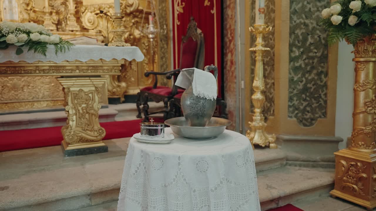 Ornate church altar prepared for baptism with liturgical vessels and linens