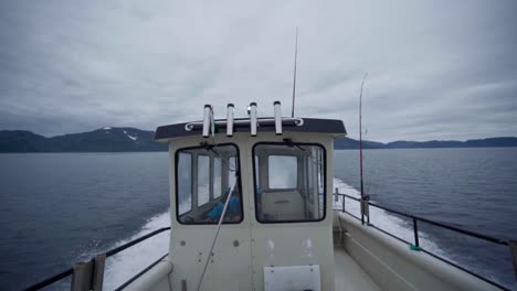 overcast sky over sailing fishing boat during hazy morning in norway