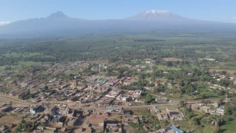 scenic panorama of african village at mount kilimanjaro footstep, aerial view