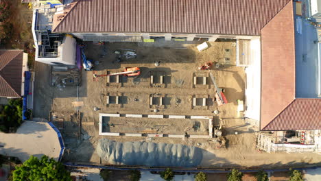 aerial view of a construction site with buildings and machinery