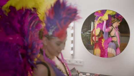 showgirls getting ready and posing in front of a mirror 2