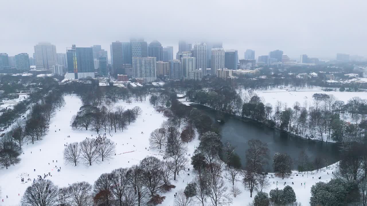 Static aerial shot of snow covered Piedmont Park and Midtown in Atlanta.