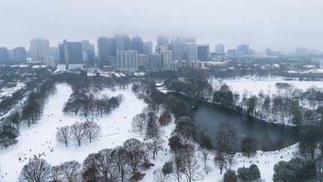 static aerial shot of snow covered piedmont park and midtown in atlanta.