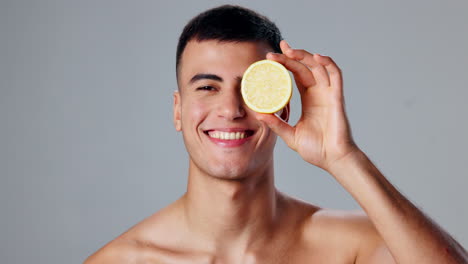 a smiling man holding a lemon