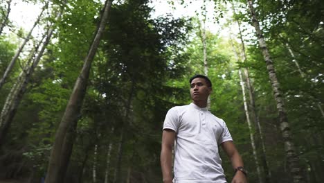 guy in the forrest looking at his watch