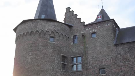 Tilt-up-of-castle-tower-with-low-sun-in-background