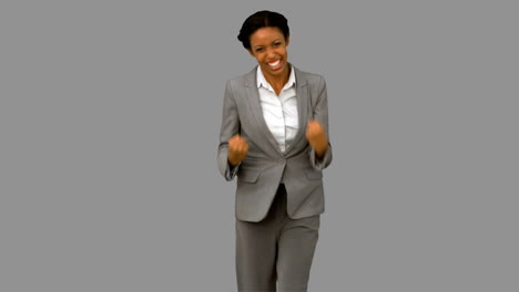 Attractive-businesswoman-gesturing-on-grey-screen