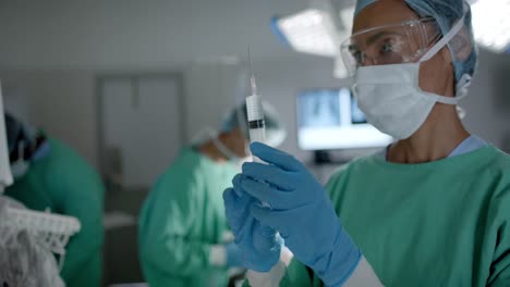 diverse surgeons with face masks preparing vaccine in operating room in slow motion