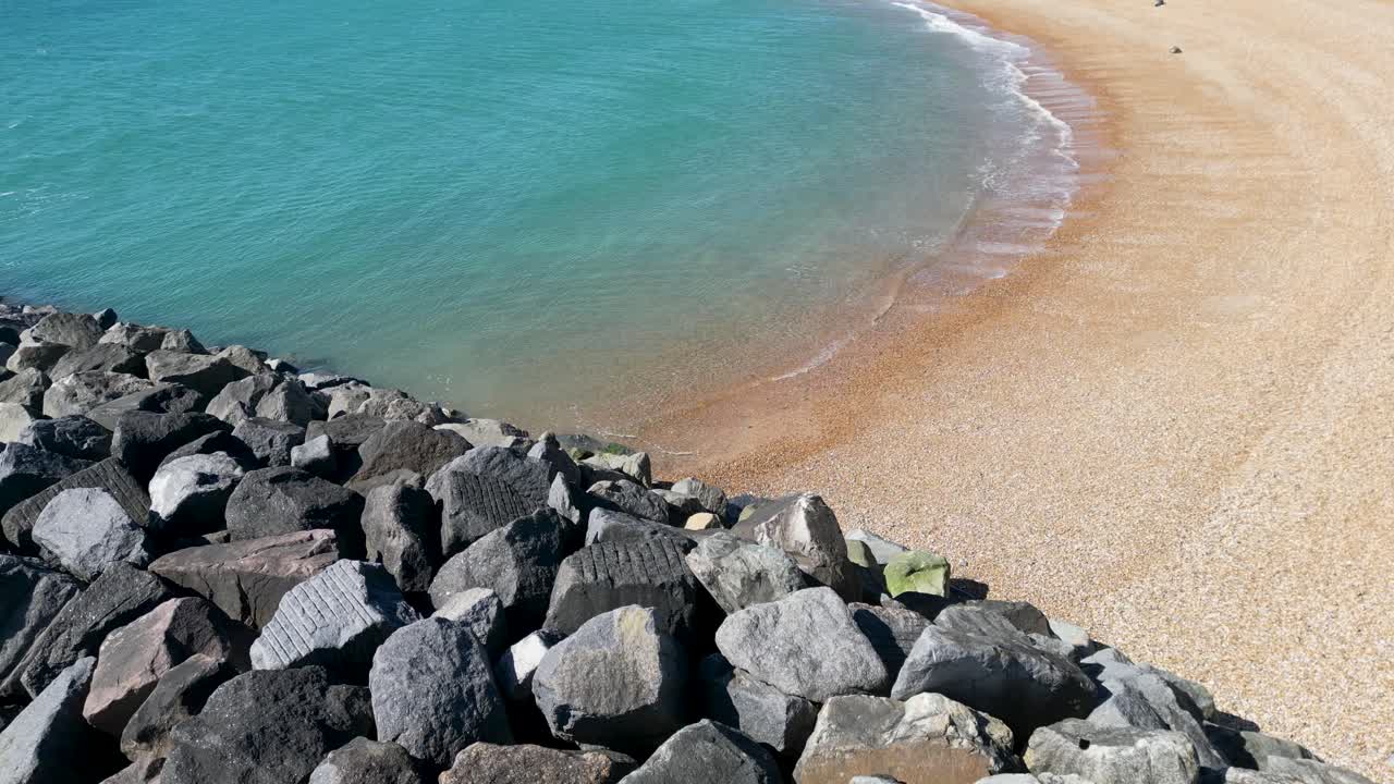Drone Flight Over Folkestone Beach Rocks in April Sunshine