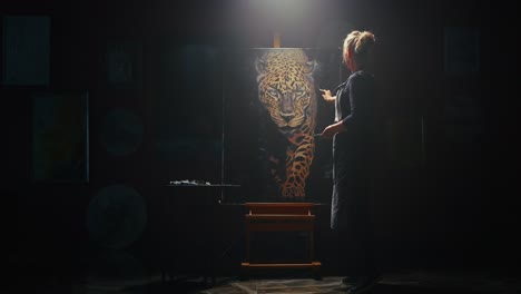 woman artist painting a jaguar