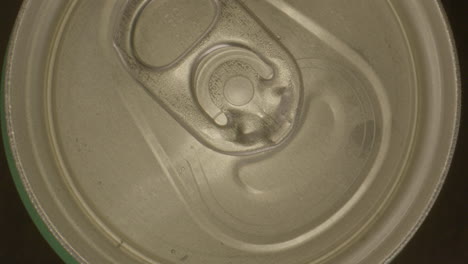 top down zoom in of lid on spinning soda can