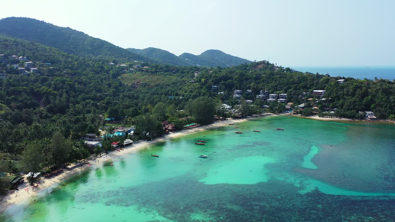 Beautiful turquoise lagoon with great coral reefs under calm clear water washing exotic beach with white sand on tropical island in Thailand