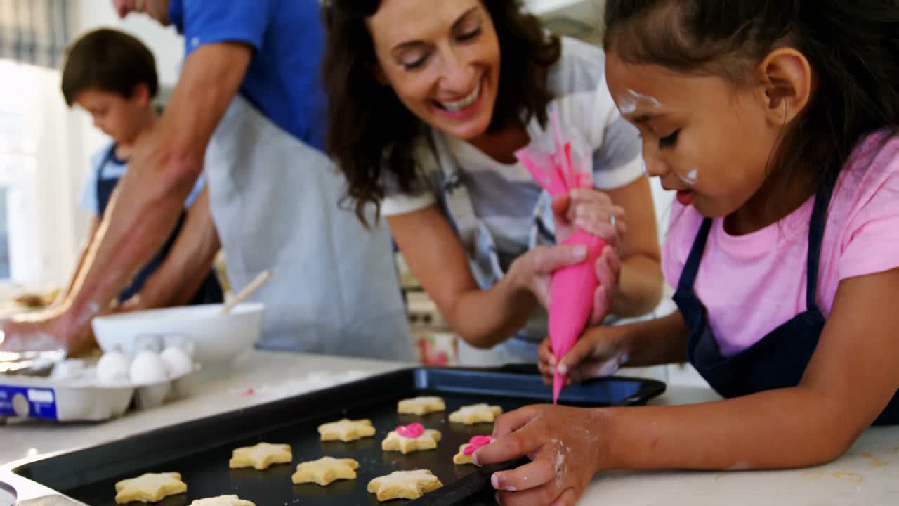Happy family preparing cookies in kitchen