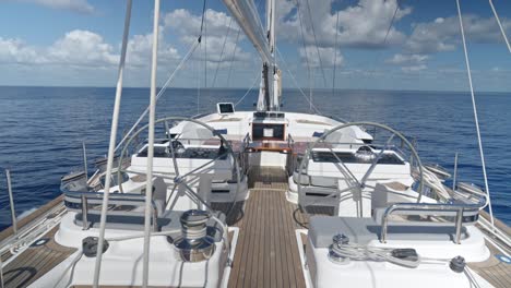 Dolly-in-shot-on-deck-of-luxury-sailing-yacht-cruising-on-the-ocean