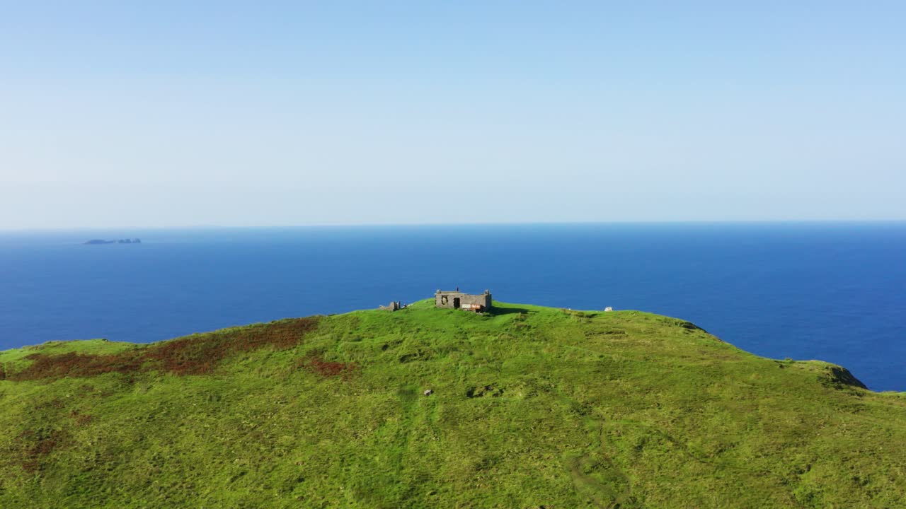 Aerial flight towards Moytoge Head lookout post near Keem Beach, Ireland