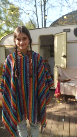 teenage girl in a colorful poncho