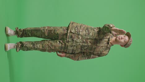 full body of asian man soldier looking at camera and disapproving with no hand sign while standing in the green screen background studio