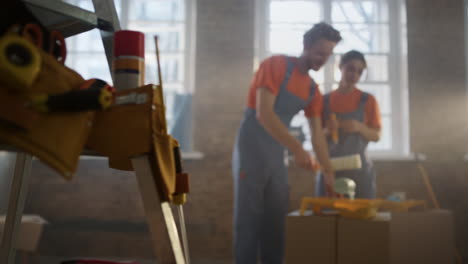 Young-family-doing-home-repair-in-new-house.-Couple-working-together-indoors.