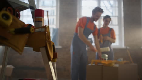young family doing home repair in new house. couple working together indoors.