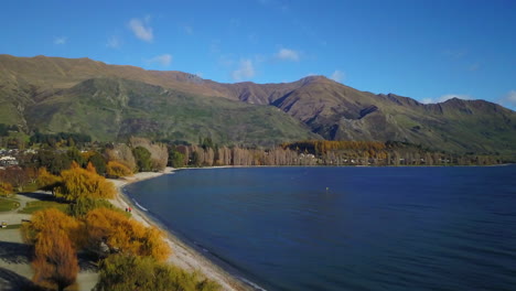 aerial drone loweriung shot of the high mountains at the blue lake wanaka