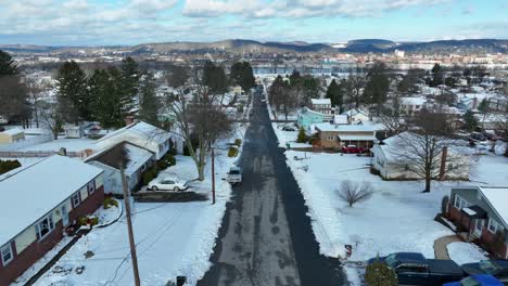 slow aerial dolly forward over snowy neighborhood