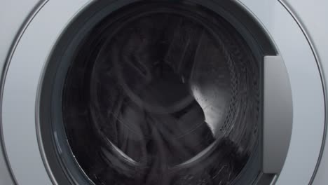 Laundry-load-mid-cycle-wet-spin-drum-close-up