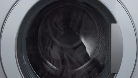 laundry load mid-cycle wet spin drum close-up