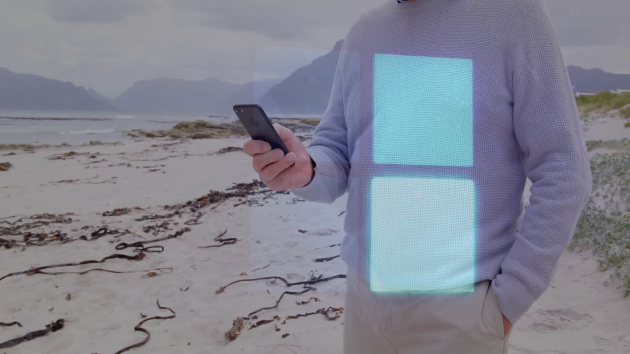 Uomo in spiaggia che usa lo smartphone, con un'animazione in sovrimpressione sullo schermo