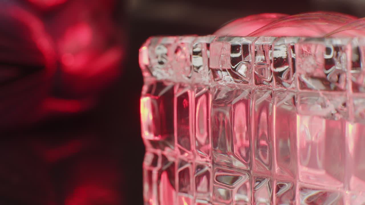 Close-up of a faceted glass box with red lighting
