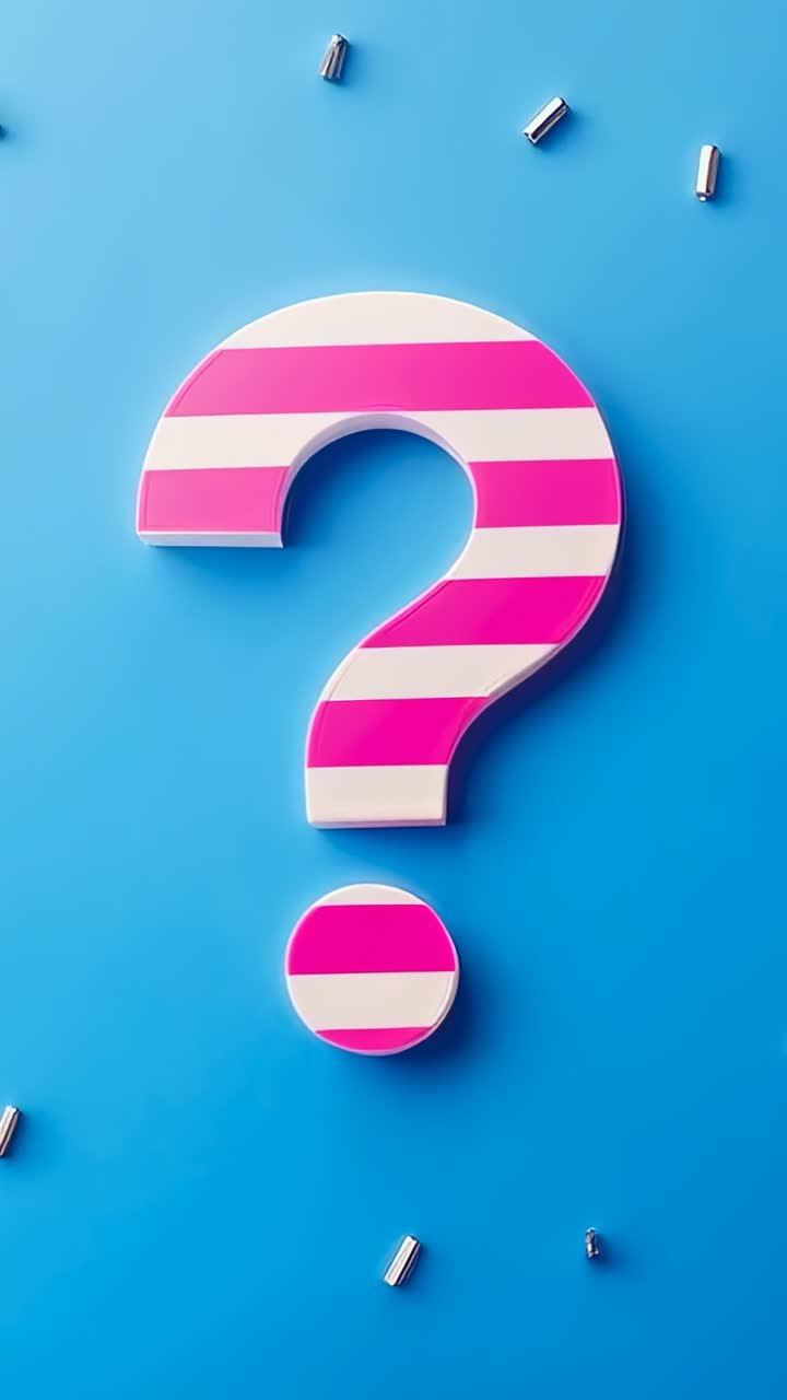 Vertical video: Zooming camera revealing pink question mark on blue set with cylinders to show form