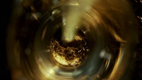 beer poured in glass against black background 4k