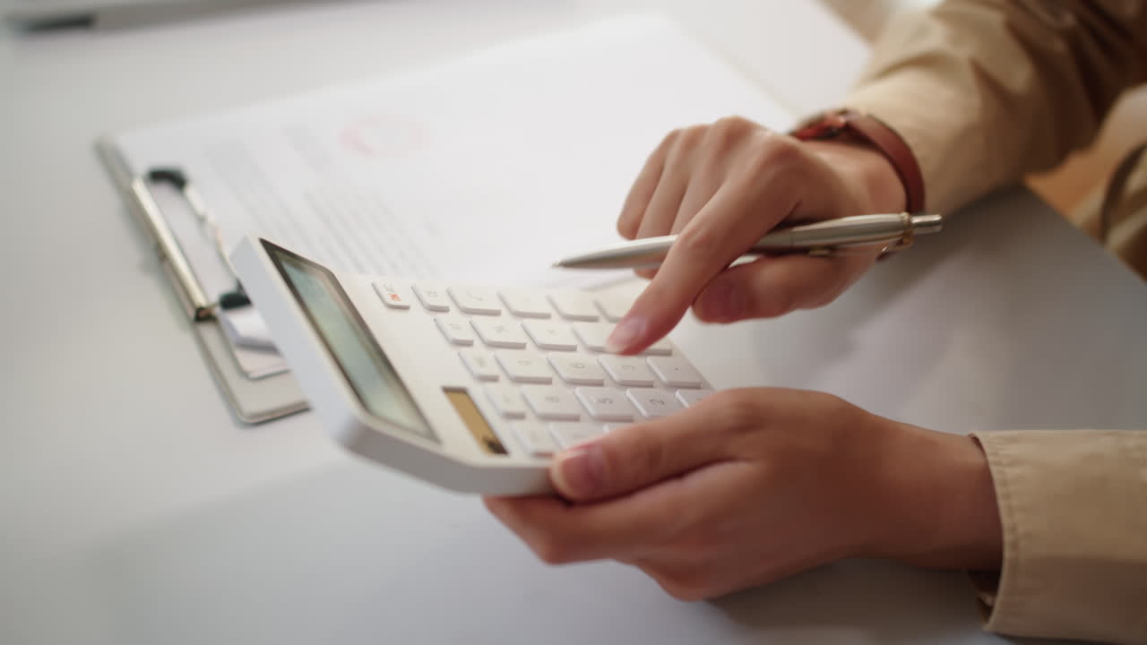Hands of Accountant Calculating Salary of Employees