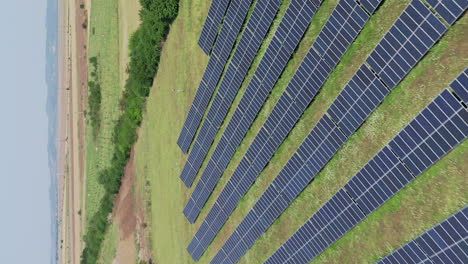 Low-reverse-flyover-above-solar-farm-and-rows-of-solar-panels