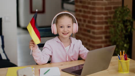 girl learning online with german flag
