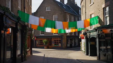 irish flags decorate a historic cobblestone street