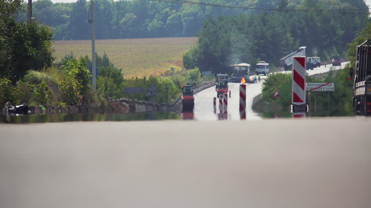 Highway repair. Road roller flattens asphalt. asphalt paver and roller