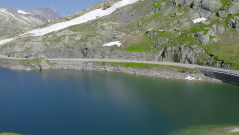 Deep-blue-lake-in-the-Swiss-Alps,-on-a-bright-clear-day