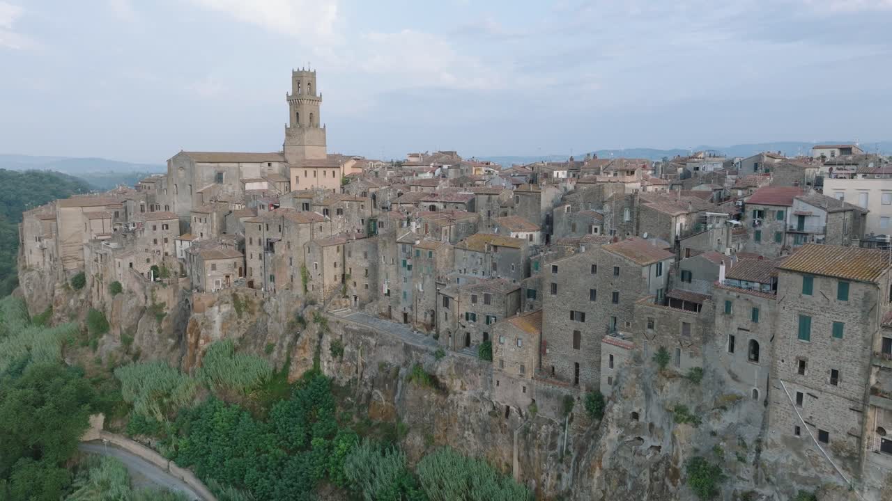 Aerial Drone view of the hilltop Medieval town of Pitigliano, Tuscany in morning light, with the Valdorcia and old buildings, in 4K