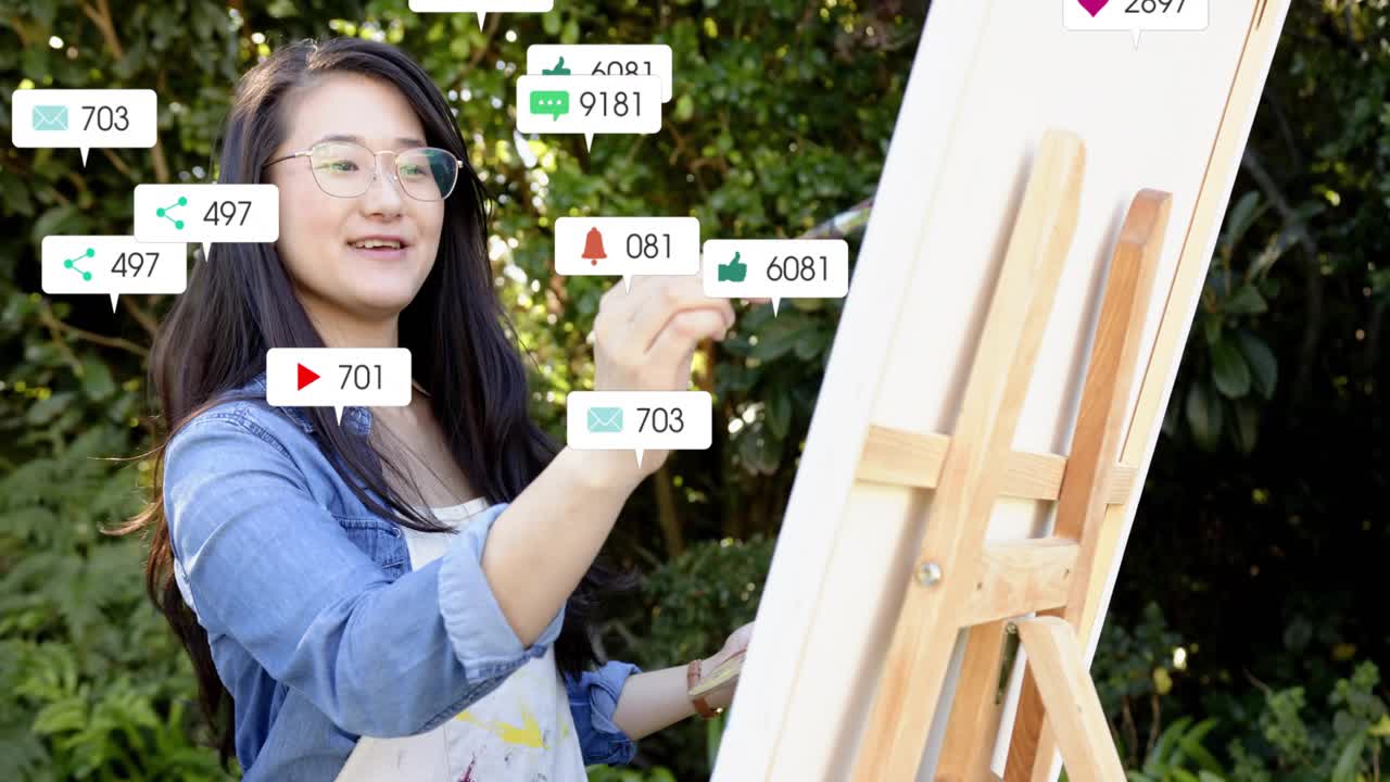 Woman painter making strokes on canvas in garden, sharing art while social icons rising over easel