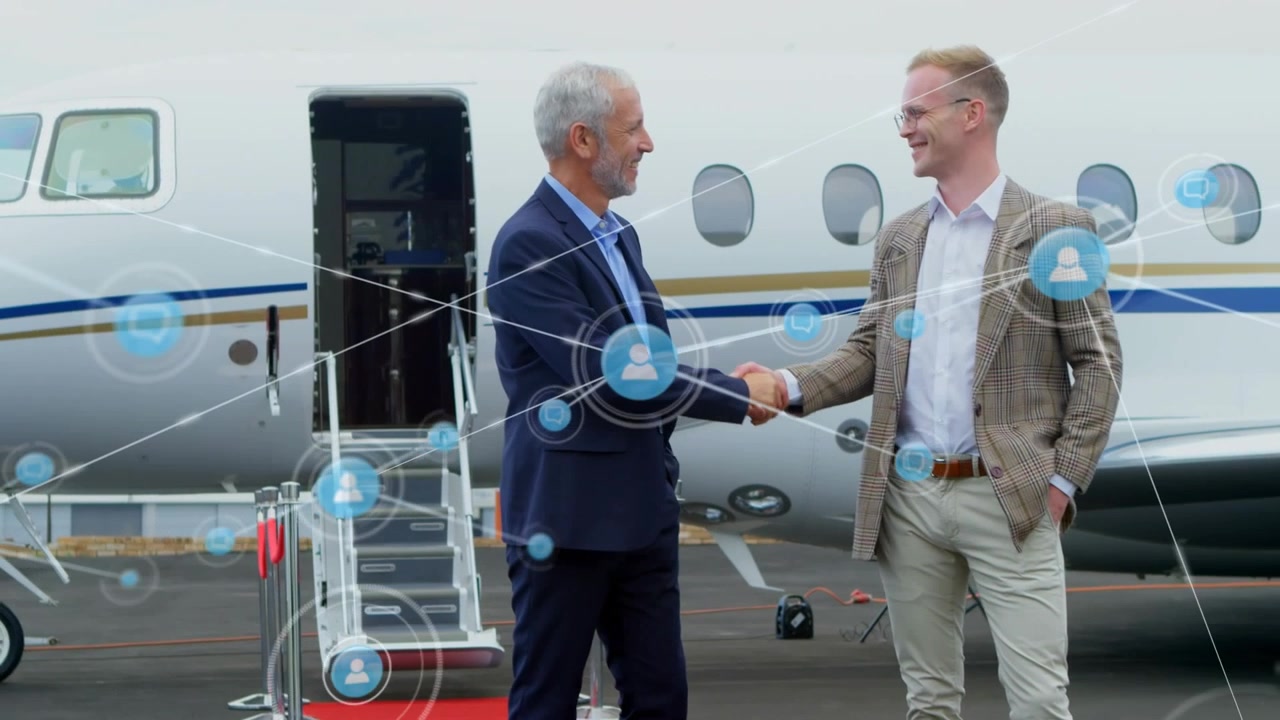 Animazione di una rete di icone digitali sopra due uomini d'affari caucasici che si stringono la mano all'aeroporto