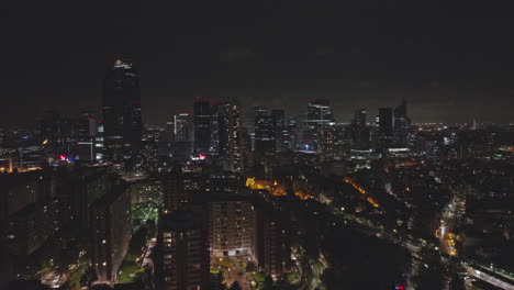 paris' nocturnal pulse: financial towers gleaming beside the seine's shimmering