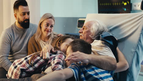 family supporting elderly patient in hospital