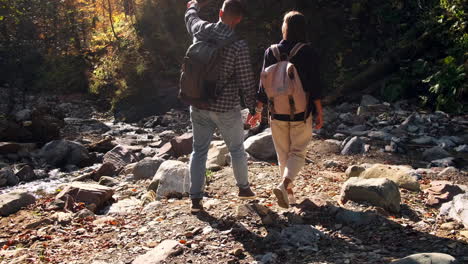 couple hiking in autumn forest