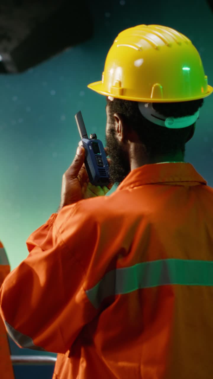 Vertical Video African american industrial worker communicate through radio devices