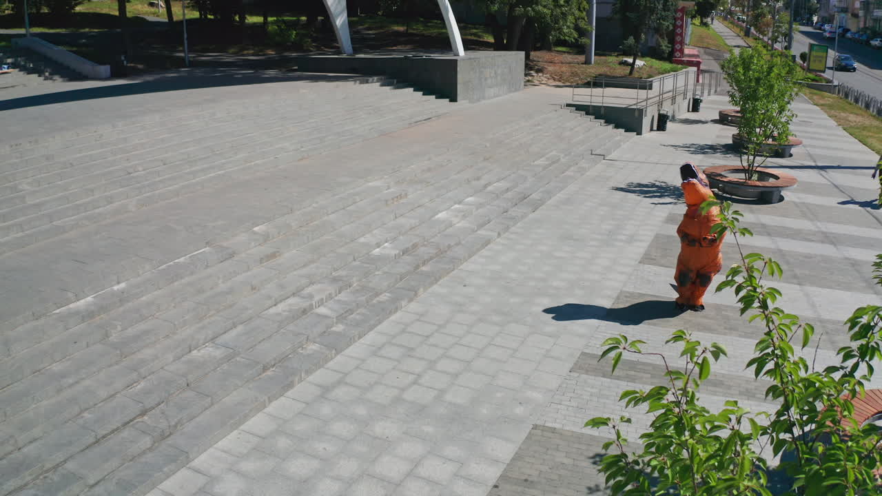 Person in a dinosaur costume in a city park