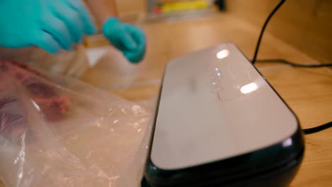 close up view of the vacuum packer shrink wraps the raw meat in preparation for sous-vide cooking