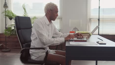 man in shirt and underpants holds online meeting by means at home
