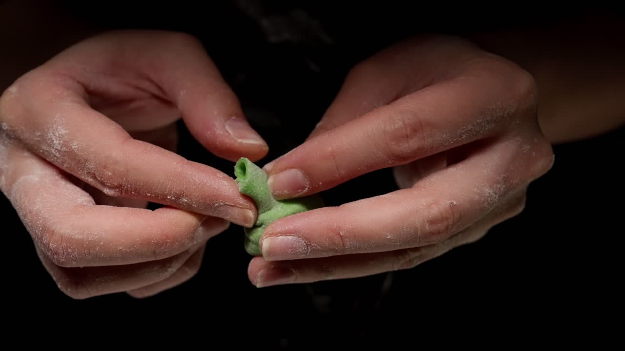 Close-up of Hands Making a Green Dumpling with Meat Filling